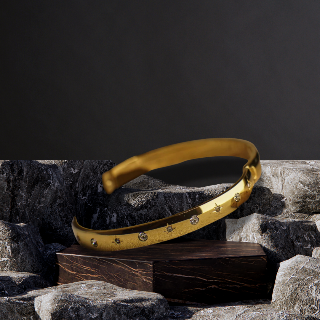 Gold headband with decorative elements on a dark stone surface