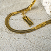 Gold bracelet with a tag on a textured surface