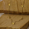 Gold necklace with floral pendants on a wooden surface