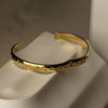 Gold bracelet on a neutral background