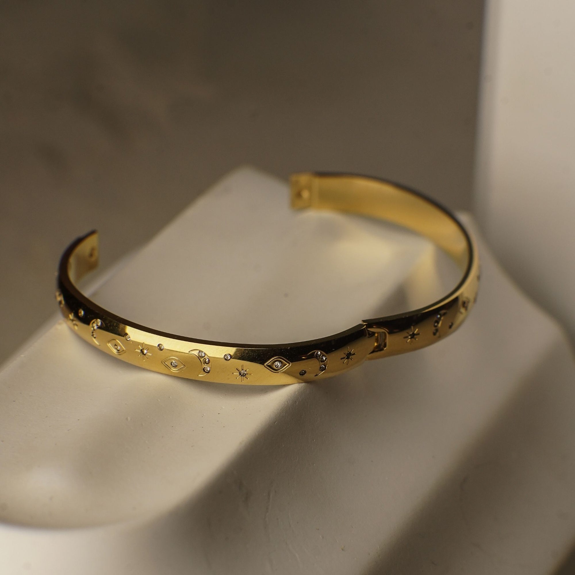 Gold bracelet on a neutral background